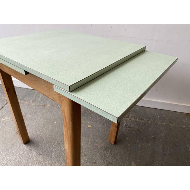 A small, Ideal practical and stylish mid-century draw-leaf dining table, dating from the 1950s–1960s. A versatile piece,...