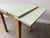 A small, Ideal practical and stylish mid-century draw-leaf dining table, dating from the 1950s–1960s. A versatile piece,...