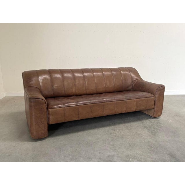 Remarks: Vintage De Sede 3 seat sofa, model DS 44. Brown, thick neck leather upholstery. Sofa is in very good vintage...
