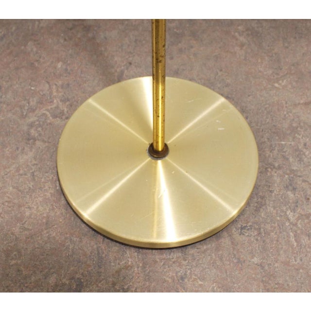 Elegant vintage floor lamp by Hans Schmidt, recognizable by its slender brass silhouette and two adjustable spotlights....