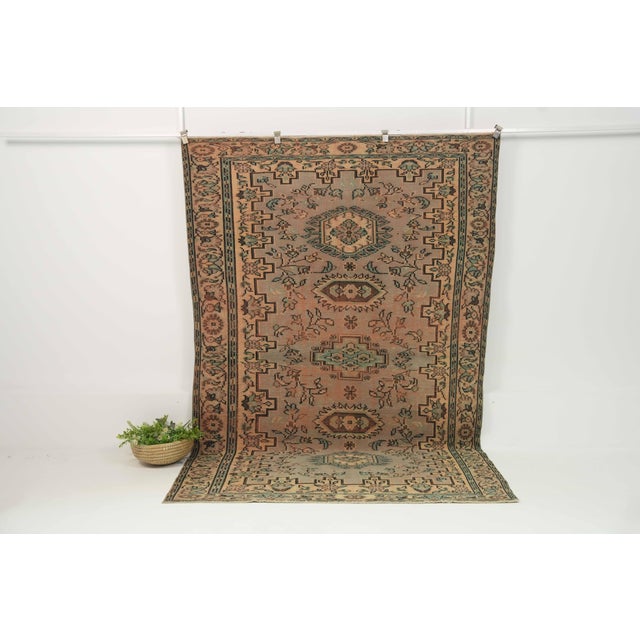 This vintage hand-knotted area rug is a semi-antique vintage area rug. The '70s Eastern Anatolian region's unique rug is...