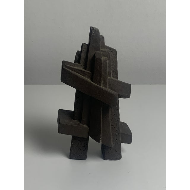 Two abstract cast concrete sculptures in the brutalist idiom. Hand-carved or hand-finished geometric forms—one with...