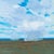 Distant Rains by Michael Magrin | Oil on linen mounted on panel landscape with distant rain clouds For Sale