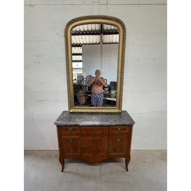 large scale antique louis Philippe carved and giltwood mirror from France. Featuring an arched top and pretty carved...