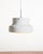 Pendant lamp in white lacquered metal with a plastic grille underneath and a double light source. Anders Pehrson for...
