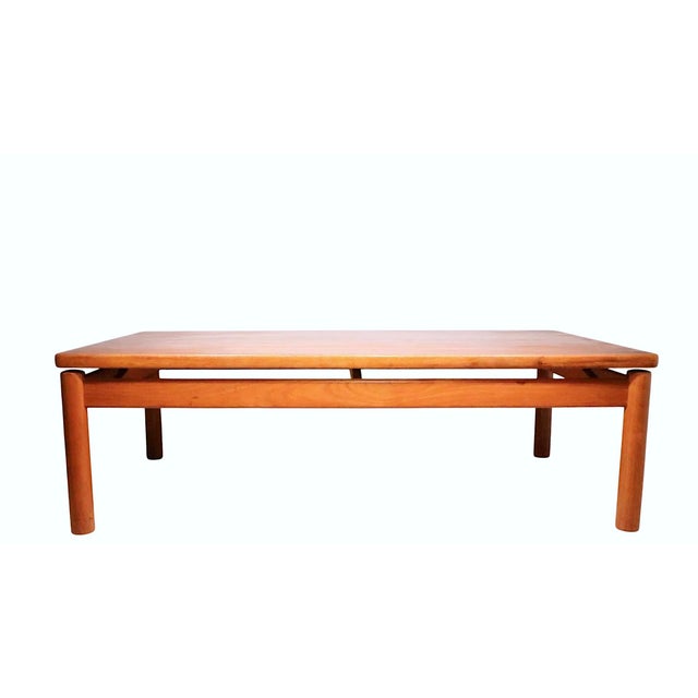 Classic Danish Modern coffee table executed in solid teak, made by Trioch 1978. This example has been newly refinished and...