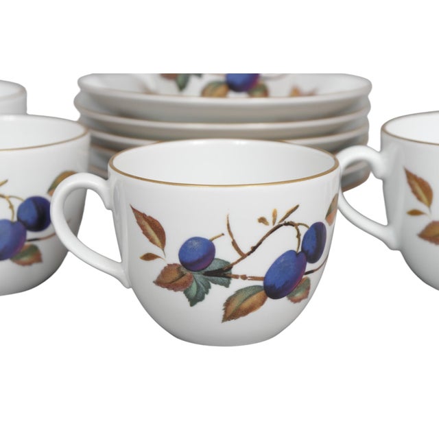 A set of six English porcelain teacups and saucers by Royal Worcester in their Evesham pattern, dated 1961. Decorated with...