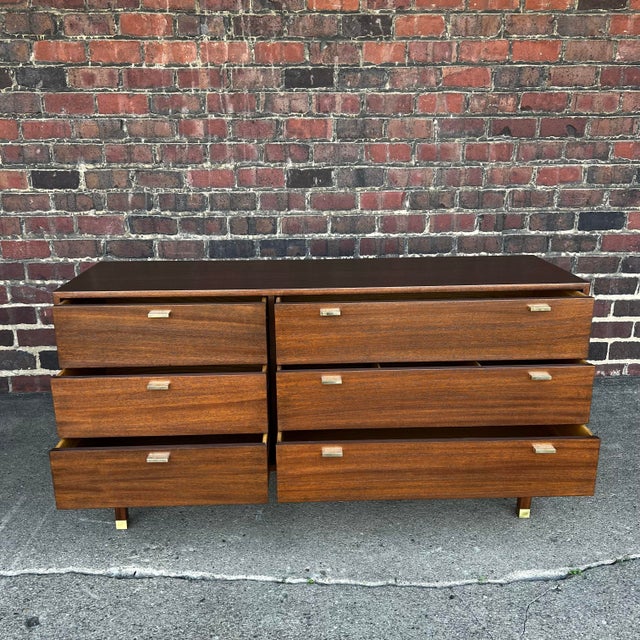 Newly refinished pair of Harvey Probber dresser in walnut. This piece comes with brass accents on the legs and all six...