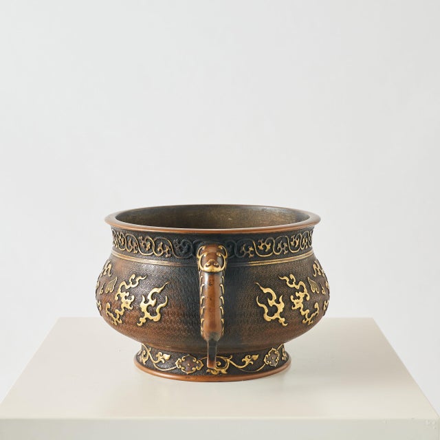 A Large Gilt Bronze Censer. A large, gilt, bronze censer with twin handles and adorned with an intricate, raised pattern....