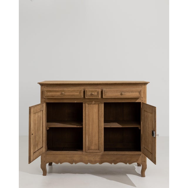 Crafted in France during the 19th century, this distinguished oak buffet embodies the graceful sensibility of the Louis XV...