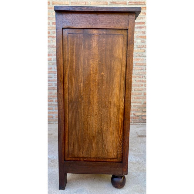 This Spanish cabinet dates from the 20th century and is crafted in oak, showcasing finely carved geometric panels inspired...