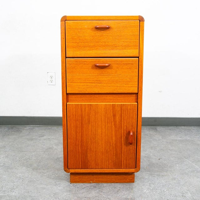A Danish Modern teak compact cabinet featuring 1 cabinet and 2 teak drawers. Made in Denmark, circa 1970s.