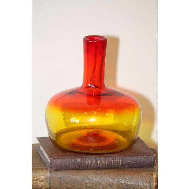 This gorgeous piece is from 1969, #6944 from Blenko. A stunning tangerine color, it reacts orange under UV light,...