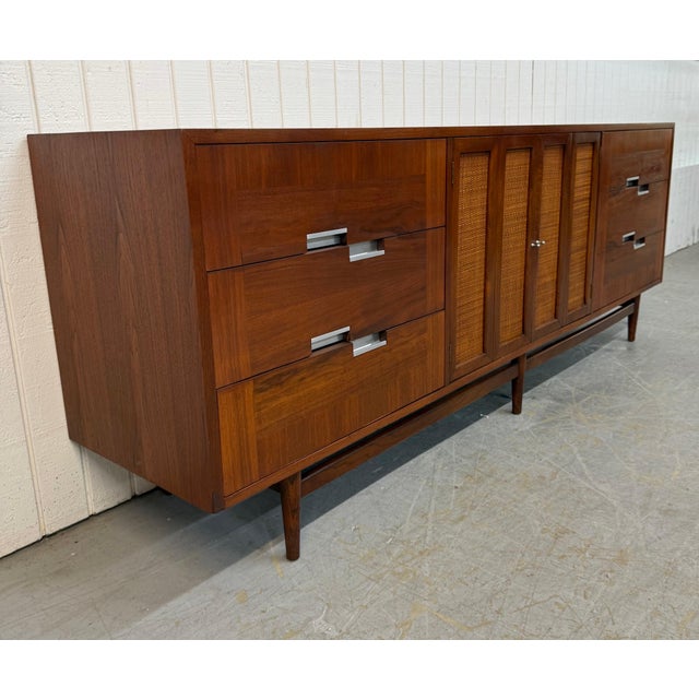 This listing is for a Mid-Century Modern Drexel Declaration Walnut Sideboard. Featuring a straight line design, push doors...