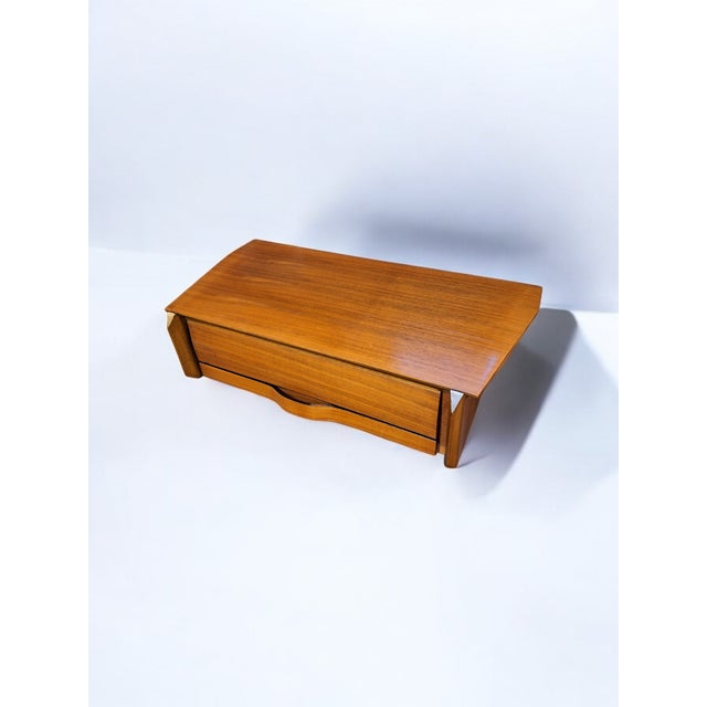 Pair of wall-mounted bedside tables produced by Permanente mobili Cantù. Structure, top and drawers in wood and handles in...