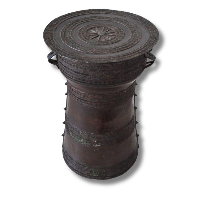 A striking Southeast Asian bronze rain drum form pedestal with beautifully engraved banding, handled sides, and a dark,...