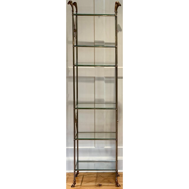 A striking French mid-century etagere in the Maison Jansen style, blending classical form with bold materials – brass,...