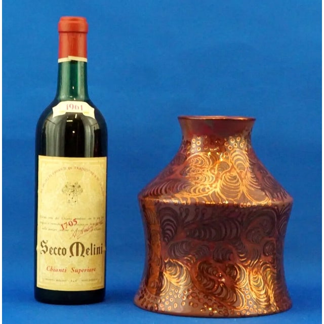 A stunning glazed and vitrified ceramic vase, entirely handcrafted on a wheel, vaguely reminiscent of an antique jar....