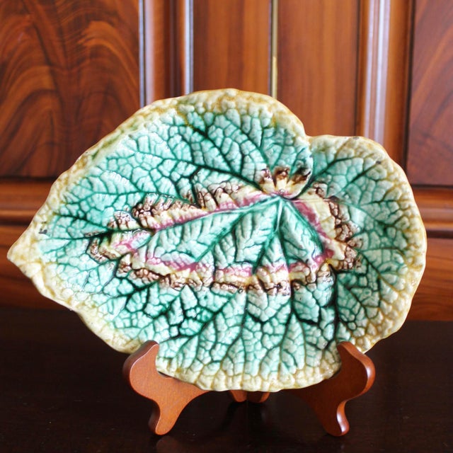 A robustly modeled and textured English majolica begonia leaf plate edged in ochre, with a green and umber center. Good...