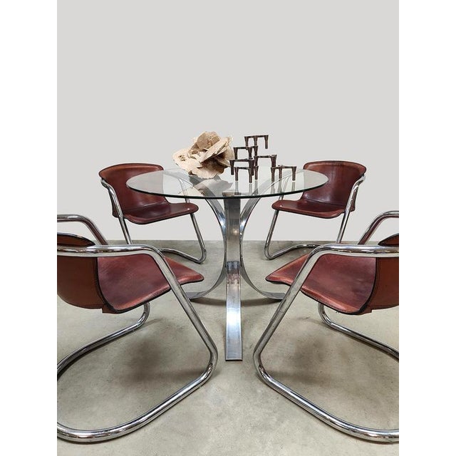 Vintage charm with a modern, timeless look. An awesome set of 4 leather chrome tubular frame chairs. The cognac leather...