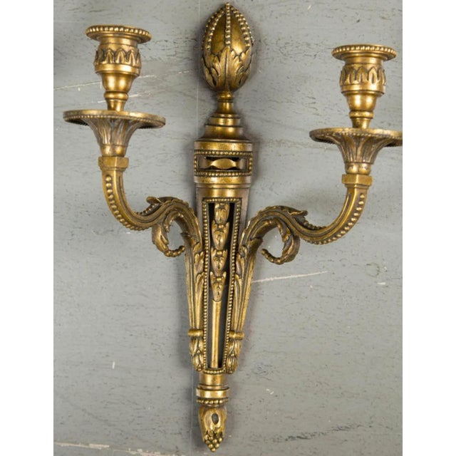 A pair of circa 1920’s Caldwell gilt bronze double lights sconces