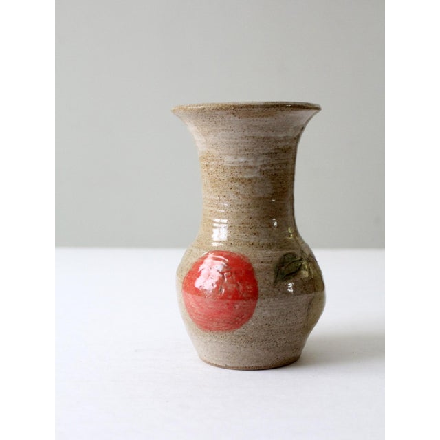 This is a vintage studio pottery vase. Signed by the artist, the large handmade vase has a hand-painted and etched apple...