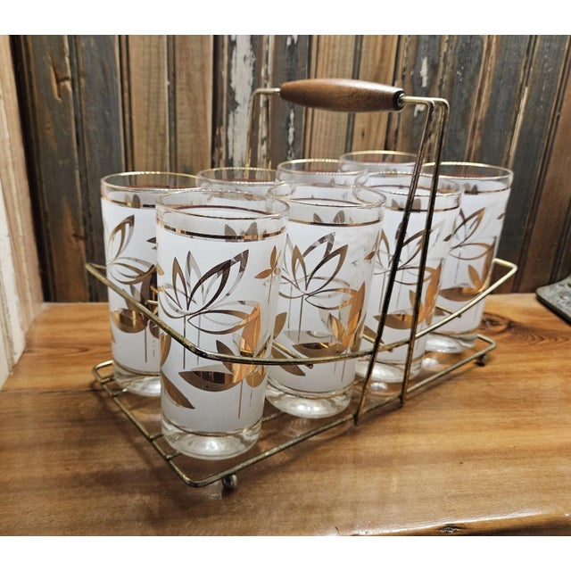 Set of 8 vintage Libby MCM retro white and gold Water Lily tall floral tumblers with wood handled gold caddy. The glasses...