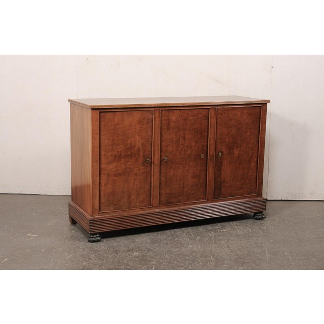 An English buffet cabinet, with reeded apron and claw feet, from the mid 19th century. This antique cabinet from England...
