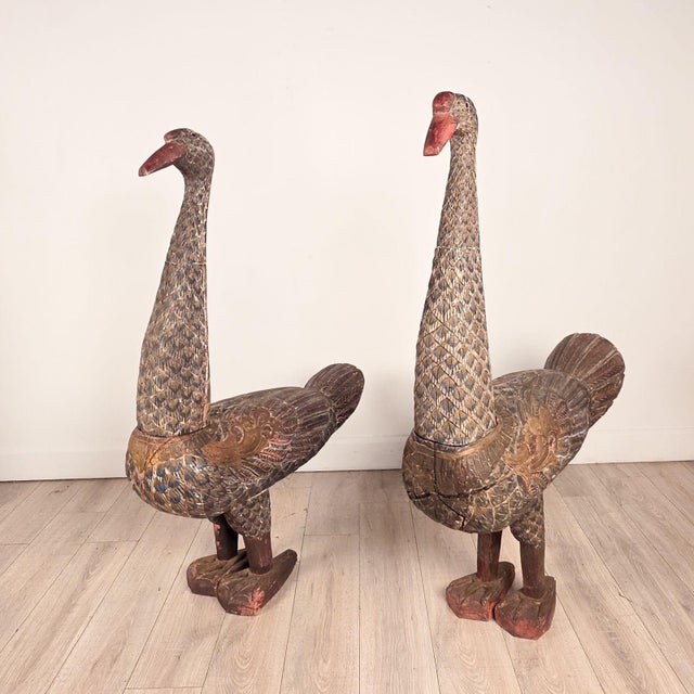 A pair of Thai carved and painted wooden geese, circa 1900. One measures 54.5" h x 38.5" w x 10.5" d, and the other...