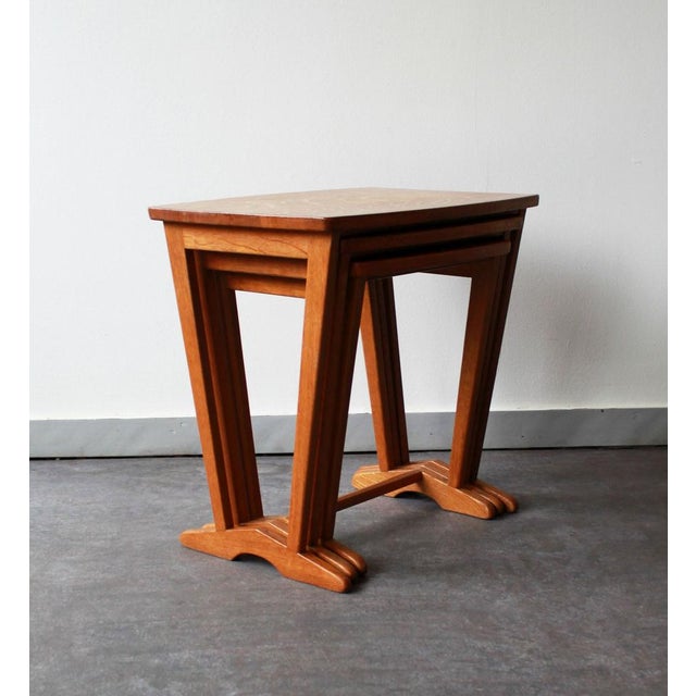 Set of 3 vintage nesting tables in solid wood, with a simple and elegant scandinavian design. Their tapered legs with a...