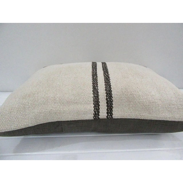 This is a pillow cover made from a vintage kilim rug. The piece was properly washed and ready to use. Pillow inserts not...