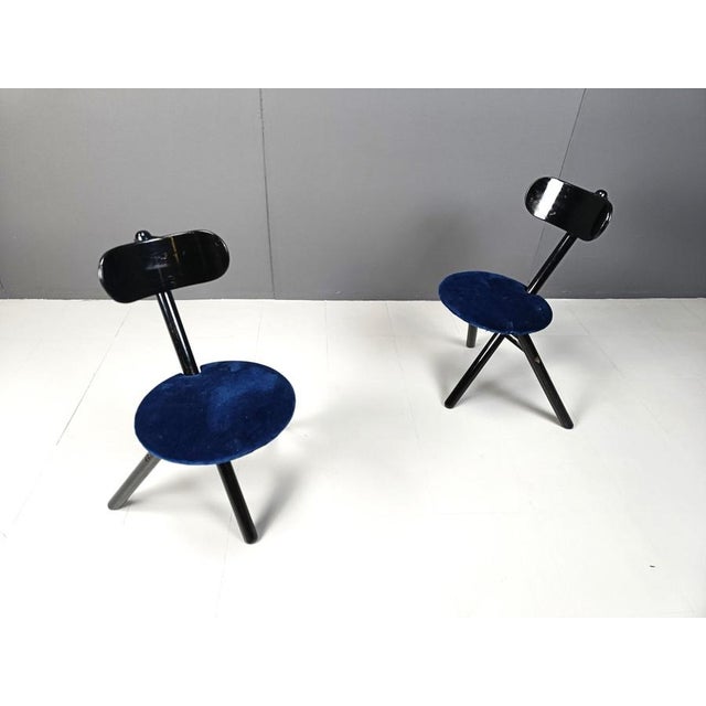 Pair of tripod foldable bar stools by Calligaris made from black lacquered wooden bases and blue velvet upholstery 1990s -...