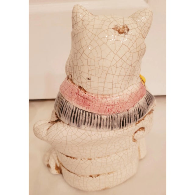 A wonderful pair of ceramic colorful Staffordshire sitting cats. The cats have a beautiful regal robe around him sitting...