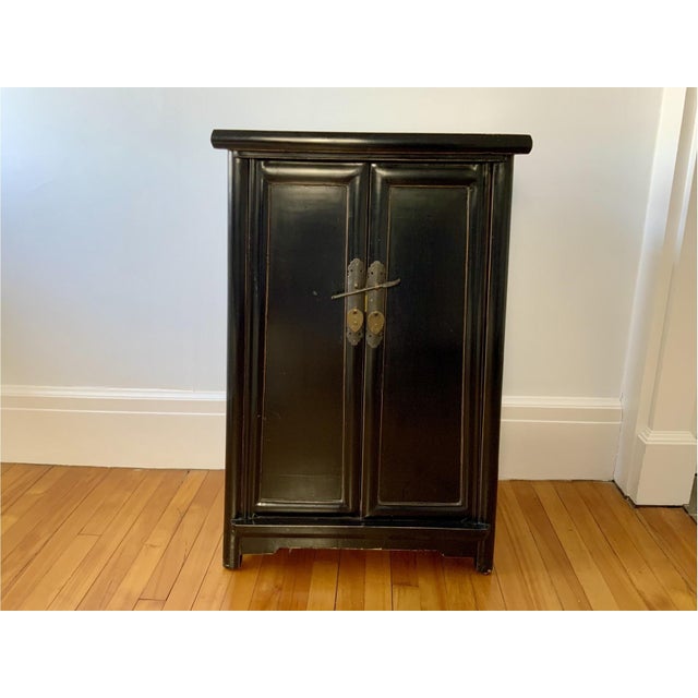 A Chinese small Ming style black lacquered cabinet chest (used traditionally for storing linens, clothing, and small...