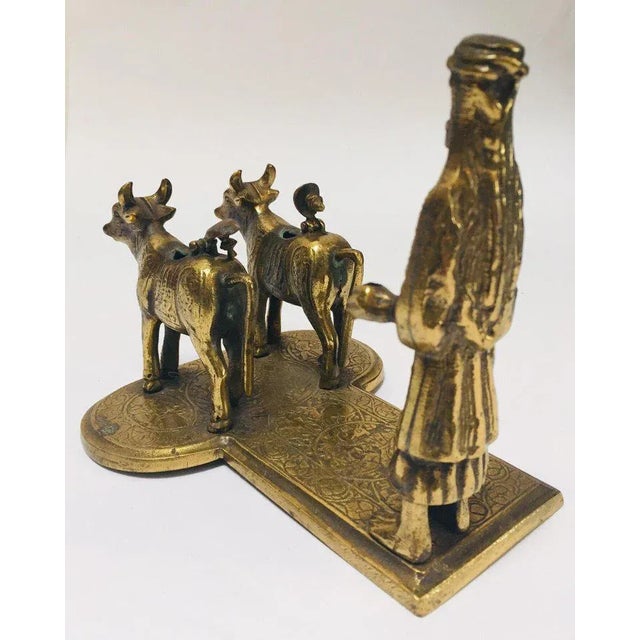 Handcrafted cast brass sculpture of cows and a holy man on stand. Cows are considered holy in India. Lord Shiva and Ma...