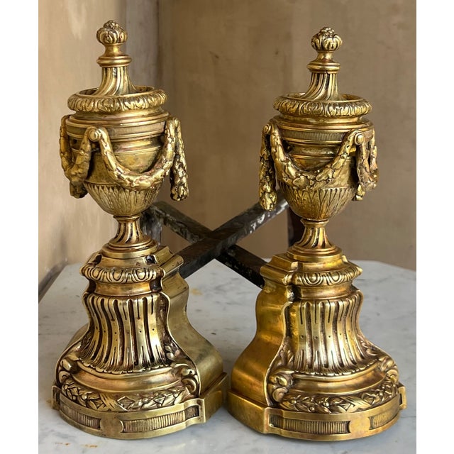 Set of two 19th century French bronze andirons / firedogs in the Louis XVI style.