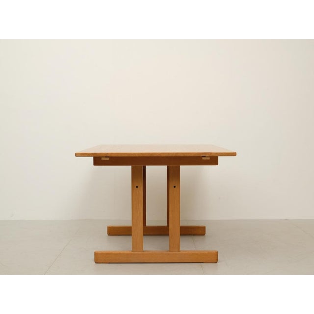 Danish dining table from the 1960s. Design: Kurt Østervig Manufacturer: K.P. Møbler The table is made of solid oak and...
