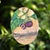 This mixed media piece features a detailed depiction of mangosteen fruit against a softly rendered urban skyline. The...