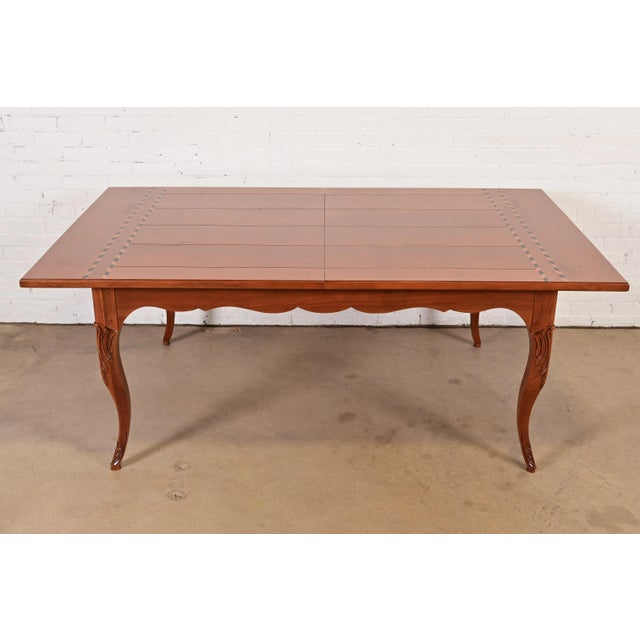 An exceptional Italian Provincial or French Country extension harvest dining table By Baker Furniture USA, Late 20th...