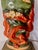 A wonderfully theatrical ceramic table lamp featuring a red-orange dragon curling around the lower body beneath a...