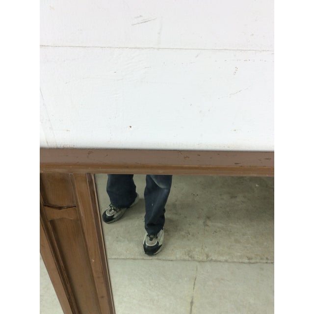 This mid century modern mirror features hardwood frame, original walnut finish, two vintage panels of mirror glass, and...