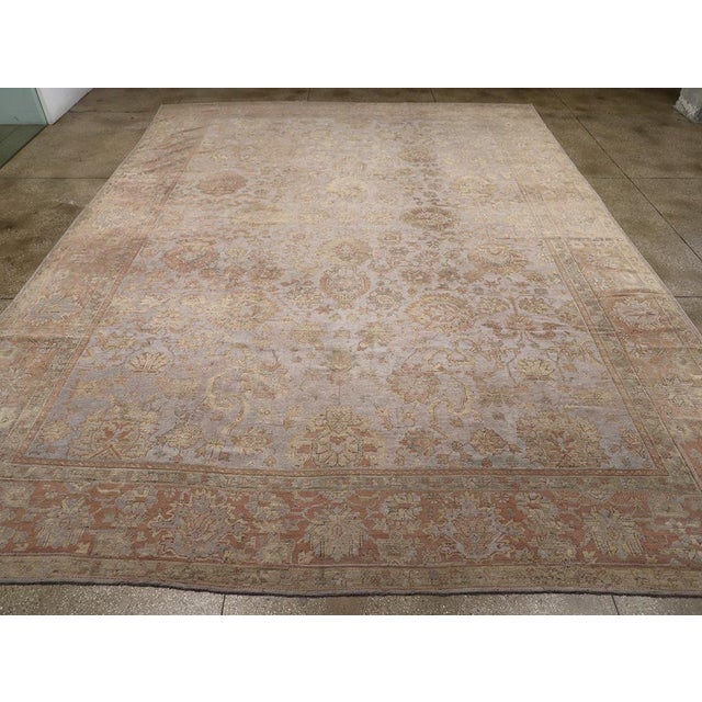 An antique Turkish Oushak large carpet handmade during the Early 20th century. Measures: 13' 6" x 18' 1"