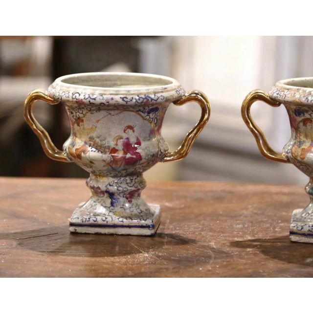 Decorate a mantel with this colorful pair of porcelain Chinese vases; created in China, circa 1970. The urn shaped vases...