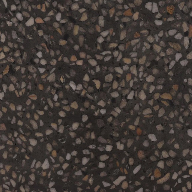 Concrete terrazzo round coffee table with black ground and speckles of browns, beiges, and grays. Perfect for outdoor or...