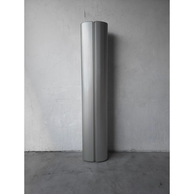 This unique wall cabinet is a highly collectible vintage piece. It is a Post Modern "The Caddy" Aluminum Cylindrical Wall...