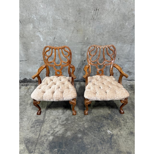Exceptional pair of antique Late Victorian carved walnut armchairs, richly detailed with intricate openwork backs and...