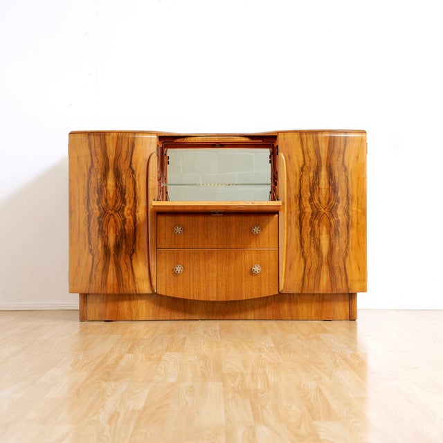 This vintage mid-century cocktail cabinet credenza was designed and manufactured by Beautility Furniture in England during...
