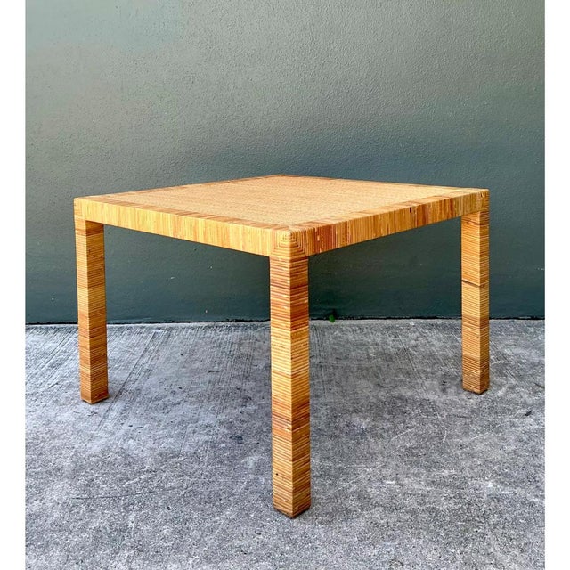 This vintage Bielecky Brothers rattan side table exemplifies the refined tropical modern aesthetic for which the brand is...