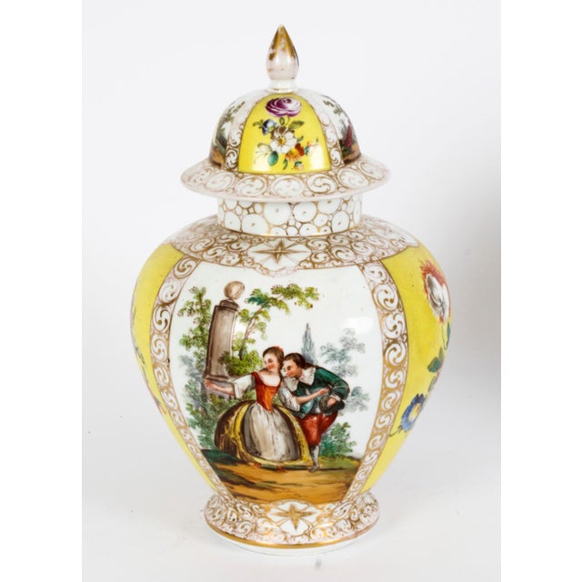 This is a beautiful pair of Dresden lidded vases and covers, circa 1900 in date. Superbly painted with panels of figural...