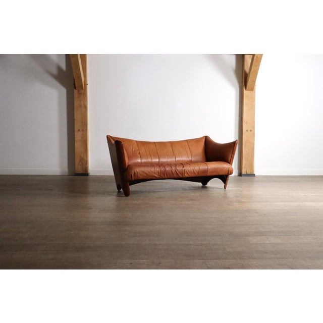 A beautiful early edition sofa model “Cayenne” in original cognac leather and coconut palm wood, made by Pacific Green in...
